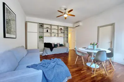a living room with a blue couch and a table at Cozy Navona Flat in Rome