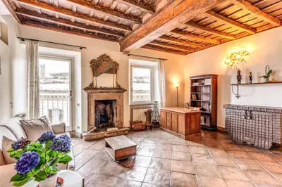 a living room with a couch and a fireplace at Flat with Lovely Views near Piazza Navona in Rome