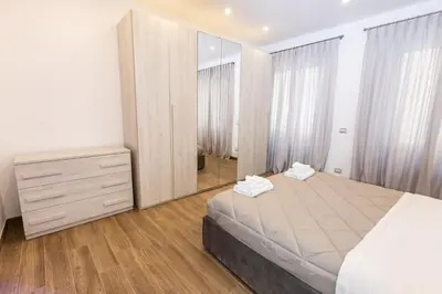 a bedroom with a bed and a large mirror at Noh Collection 2BDR apartment- Vatican Area in Rome