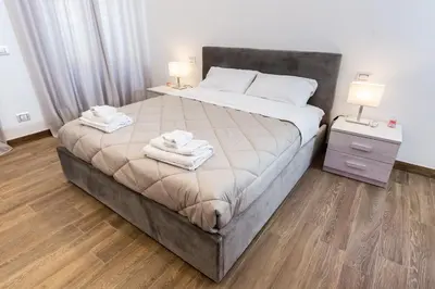 a bedroom with a large bed with two towels on it at Noh Collection 2BDR apartment- Vatican Area in Rome