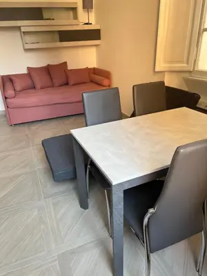 a living room with a table and a couch at Sant'Angelo House in Rome