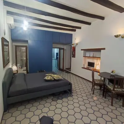 a bedroom with a bed in a room with a table at Casa Claudia ~ rione Monti-Colosseo in Rome