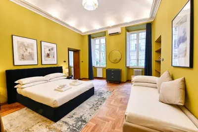 a bedroom with a bed and a couch at Elegant oasis among the Vatican and Via del Corso in Rome