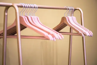 two pink chairs are hanging on a rack at Elegant oasis among the Vatican and Via del Corso in Rome