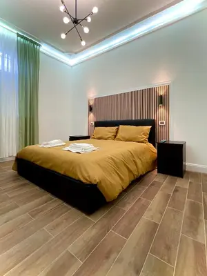 a bedroom with a large bed with a wooden floor at Avocado House - Cozy Apartment in the Heart of Rome in Rome