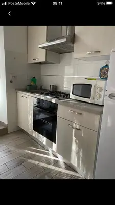 a kitchen with a stove and a microwave on the counter at Colibrì Apartment in Rome