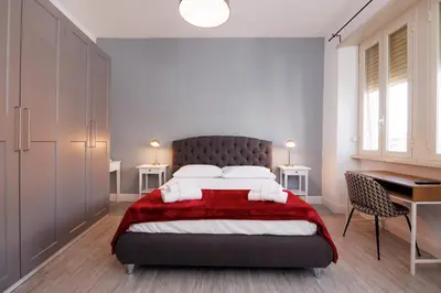 a bedroom with a large bed and a desk at Casa Boccea 112 in Rome