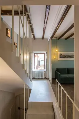 a staircase in a room with a green couch at Frangipane 31 Monti Terrace in Rome