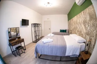 a bedroom with a bed and a table with a mirror at Vatican Fashion Home in Rome