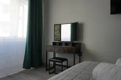 a bedroom with a desk with a mirror and a bed at Vatican Fashion Home in Rome