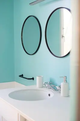 a bathroom with a sink and two mirrors on the wall at Casa Mirabella in Rome