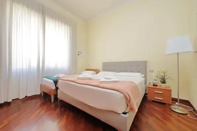 a bedroom with a large bed and a window at 4BNB - Cimabue Apartment in Rome