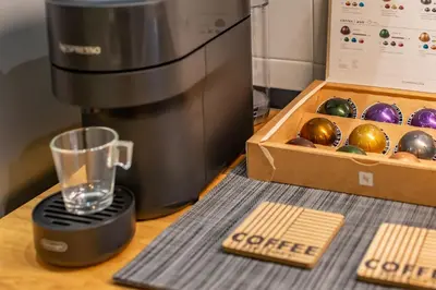a coffee maker next to a box of ornaments at Imperium House - appartamento con giardino privato, 3 minuti da Metro Piazza Bologna, A-C, in Rome