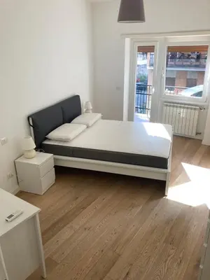 a bedroom with a large bed in a room at Casa Caravella in Rome