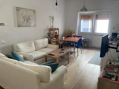 a living room with two white couches and a table at Casa Caravella in Rome