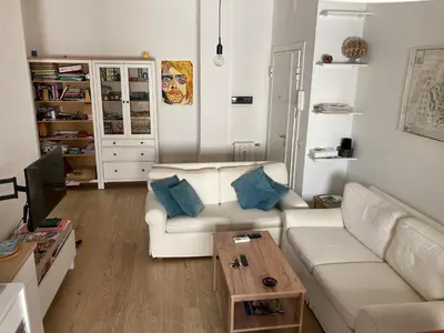 a living room with a white couch and a table at Casa Caravella in Rome