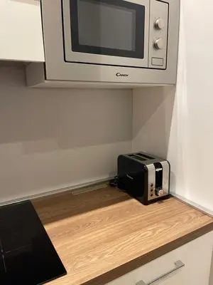 a microwave and a toaster oven sitting on a counter at La casa di Jonathan al Ghetto in Rome