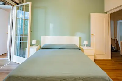 a bedroom with a large bed with two lamps at Limacino in Rome
