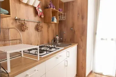 a kitchen with a sink and a stove at La casa di Marisela in Via Emanuele Filiberto in Rome