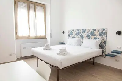 a small bedroom with a bed with towels on it at Domus Viola in San Giovanni in Rome