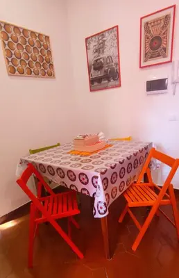 a table with two chairs and a table cloth on it at Casetta del Quadraro in Rome