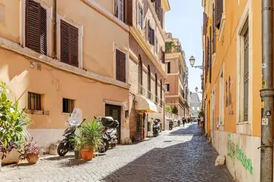 an alley with motorcycles parked on the side of buildings at Loft Colosseo, in Rome Center in Rome