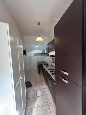 a kitchen with a refrigerator and a counter top at Ragusa Holiday Home in Rome