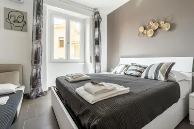 a bedroom with a bed with towels on it at Maison del Re - San Giovanni by RHR in Rome