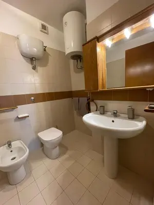 a bathroom with a sink and a toilet and a mirror at Stanza Eur Tintoretto in Rome