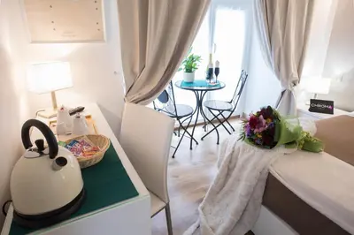 a small room with a bed and a table with a tea kettle at Chroma Italy - Chroma Octho in Rome
