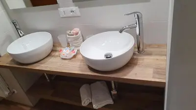 a bathroom with two sinks on a wooden counter at Melory House in Rome