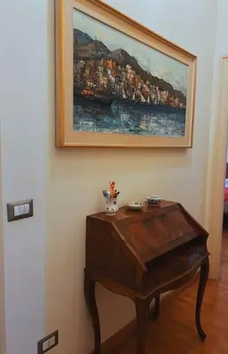 a wooden table in a room with a painting on the wall at Joyful Home in Rome