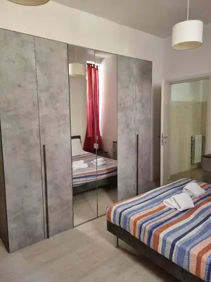 a bedroom with a bed and a mirror at Ad un passo dal Vaticano in Rome