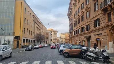 a city street with cars parked on the street at Ad un passo dal Vaticano in Rome
