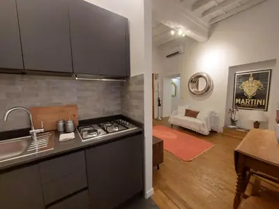 a kitchen and a living room with a counter top at pantheon luxury apartment in Rome