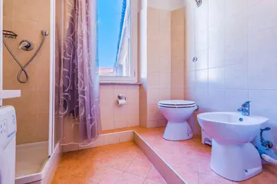 a bathroom with a toilet and a sink and a shower at Vatican Place in Rome