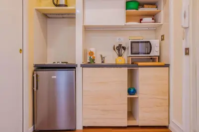 a small kitchen with a refrigerator and a microwave at Vatican Place in Rome
