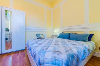 a bedroom with a bed with a blue comforter at Vatican Place in Rome