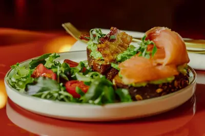 a plate of food with a salad on a table at Residenza Piranesi Boutique Hotel in Rome