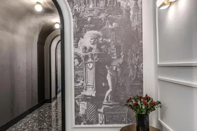 a hallway with a large painting on the wall at Residenza Piranesi Boutique Hotel in Rome