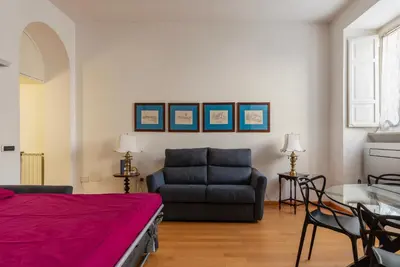 a living room with a couch and a table at GuestHost - Tra Castel Sant'Angelo e Città del Vaticano Flat in Rome