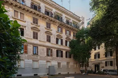 a large brick building with windows on a street at GuestHost - Tra Castel Sant'Angelo e Città del Vaticano Flat in Rome