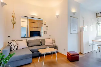 a living room with a couch and a table at Nonna Cocchina House Rome close to Vatican City in Rome