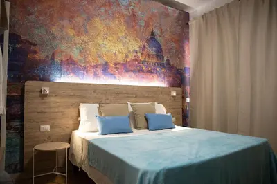 a bedroom with a bed with a painting on the wall at Domus Coriolano in Rome