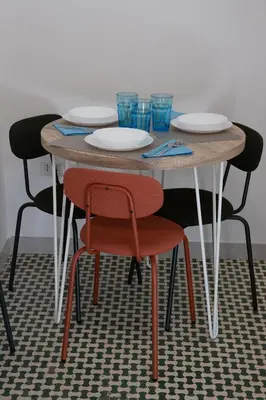 a wooden table with chairs and plates and glasses on it at Domus Coriolano in Rome