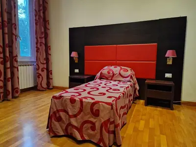 a bedroom with a bed with a red bedspread at Domus Lilium in Rome