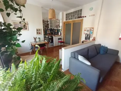 a living room with a couch and some plants at Casa Bambù in Rome
