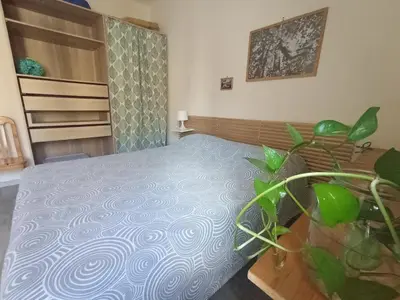 a bedroom with a bed and a potted plant at Casa Bambù in Rome