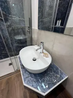 a bathroom with a white sink on a marble counter at Ele Suites Pantheon in Rome