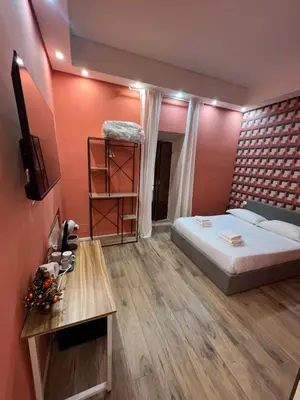 a bedroom with a bed and a book shelf at Ele Suites Pantheon in Rome